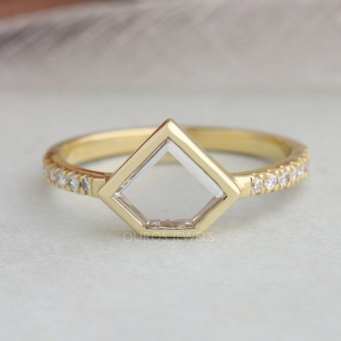 pentagon portrait cut diamond bezel set engagement ring's front view on grey fabric