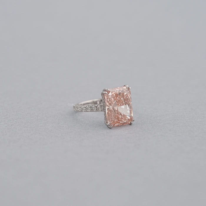 side view of pink radiant-cut diamond double-prong solitaire accent engagement ring