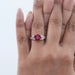 pink ruby cushion cut gemstone solitaire split-shank wedding ring in finger