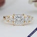 front view of princess cut diamond five stone engagement ring in yellow gold band