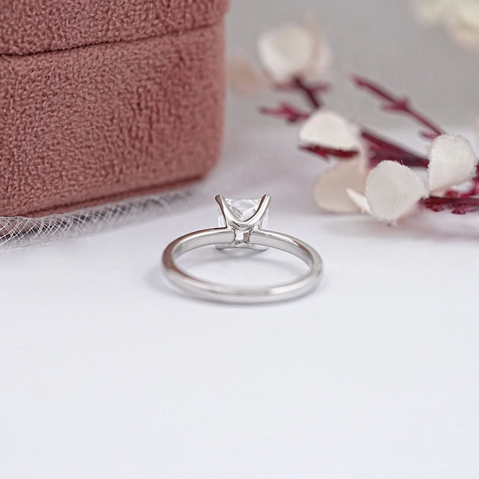 princess cut certified diamond solitaire engagement ring in model's finger