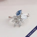 Blue pear and round lab grown diamond cluster engagement ring in 14k white gold