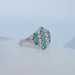 side view of round cut paraiba gemstone bezel set engagement ring