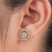 Round Brilliant Cut Diamond Halo Stud Earrings worn on an ear, showcasing their sparkling design and elegance.