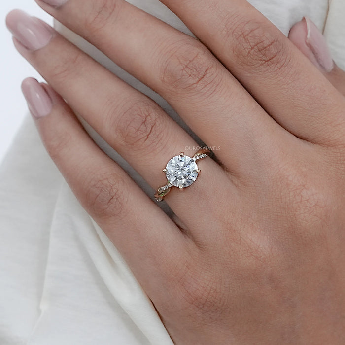 twisted round-cut lab diamond solitaire accent anniversary ring on model's finger