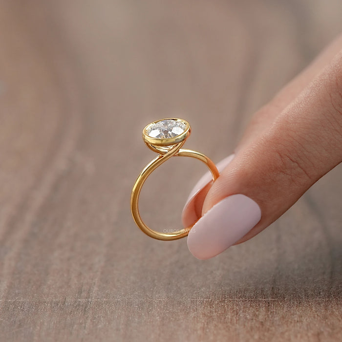 side view of bezel set engagement ring with a round lab diamond