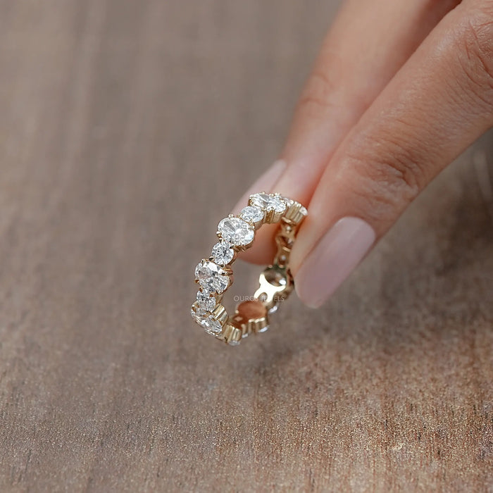 side view of oval and round lab created diamond eternity wedding ring yellow gold