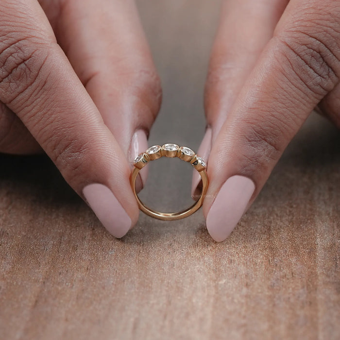 close view of five stone round cut lab diamond bezel set engagement ring