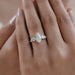 marquise and round cut lab diamond five stone engagement ring on model's finger