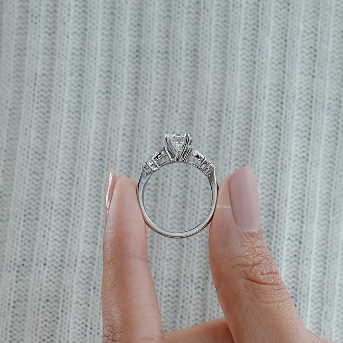 close view of round and pear cut lab diamond five stone engagement ring