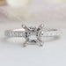 front view of round-shaped hidden halo semi-mount engagement ring on grey fabric