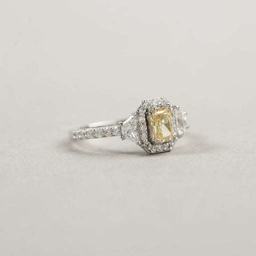 right view of yellow radiant cut diamond three stone halo engagement ring