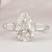 front view of pear cut with tapered baguettes diamond three stone wedding ring