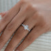 oval and pear cut lab diamond five stone engagement ring in finger