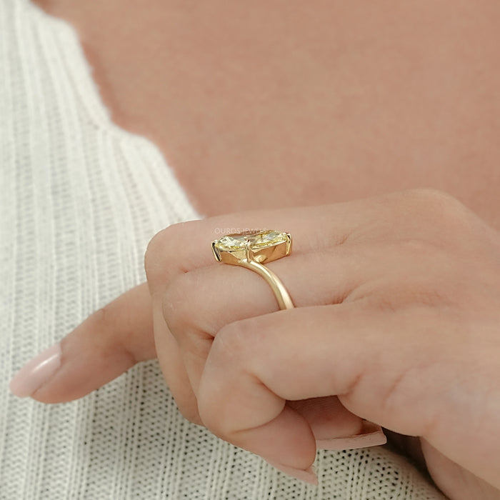 yellow old mine marquise lab diamond V-shape colored wedding ring on model's finger