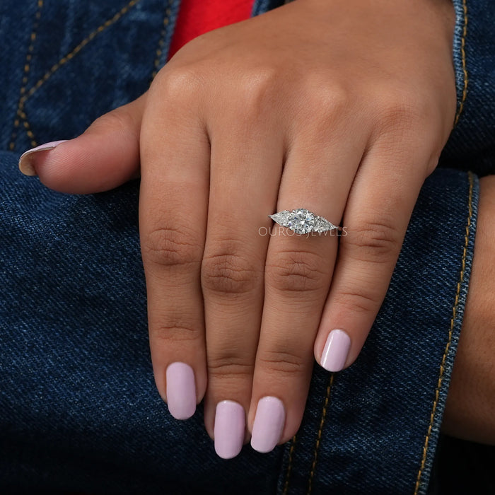 In Finger View Of Round Diamond Three Stone Engagement Ring