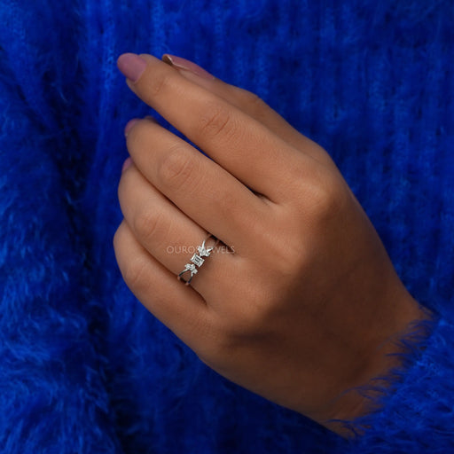 In finger front look of emerald cut cluster diamond ring made of VS clarity & 14k white gold.