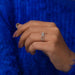 In finger side view of emerald cut cluster ring with VS clarity, a perfect gift for your partner.