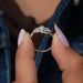 In finger side look of oval brilliant cut lab made diamond engagement ring