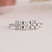 Close up view of oval cut cluster diamond ring with side round cut small diamonds.