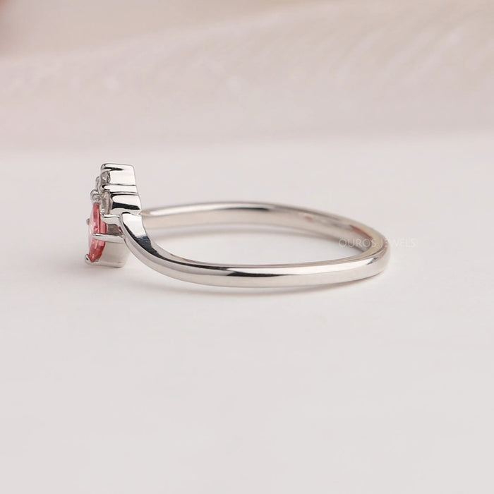Side view of princess cut pink diamond ring made of curved band in 14k white gold.