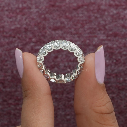 close view of cushion cut diamond eternity band engagement ring white gold