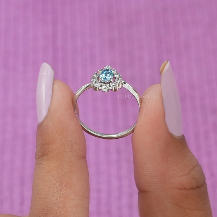 The ring's shank is adorned with smaller diamonds, sparkling with every movement of the hand