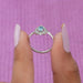 The ring's shank is adorned with smaller diamonds, sparkling with every movement of the hand