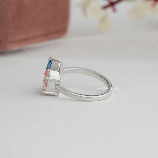 side view of blue marquise and pink pear lab diamond toi et moi engagement ring