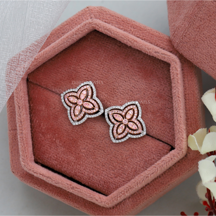 side view of pink round cut lab diamond flower stud earrings on jewelry box