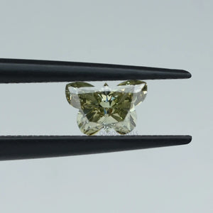 green colored butterfly shape lab diamond holded with black tweezer