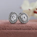 Oval brilliant cut lab created diamond stud earrings with claw prongs and sparkling halo of round diamonds