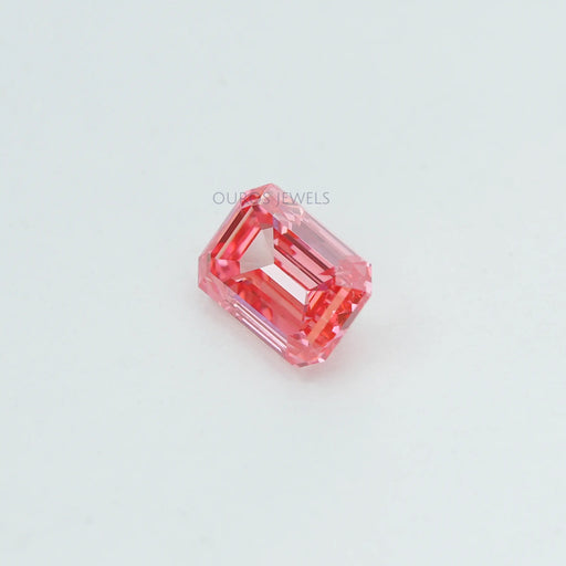 side view of 0.76 ct pink lab made emerald diamond loose on fabric