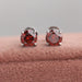 A pair of Red Round Cut Eco Friendly Diamond Stud Earrings