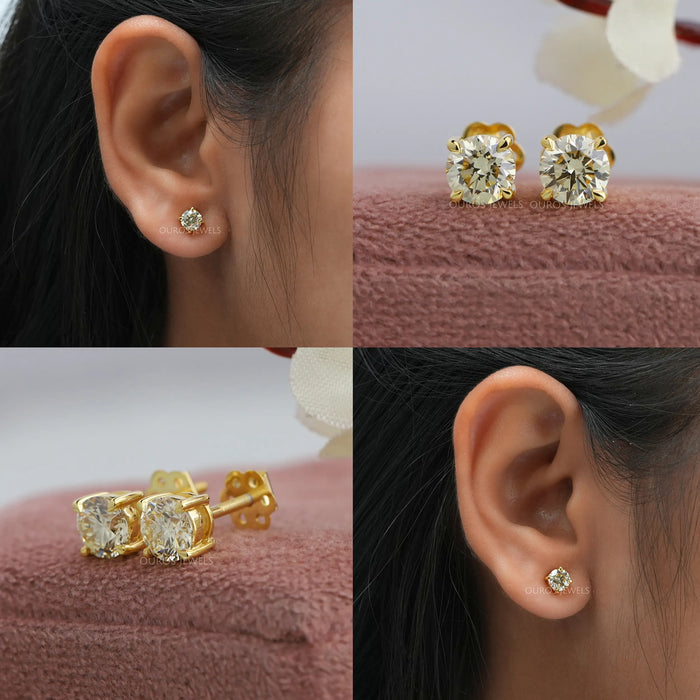 These yellow gold solitaire earrings feature a classic design, with round cut diamonds set in a secure claw prong setting