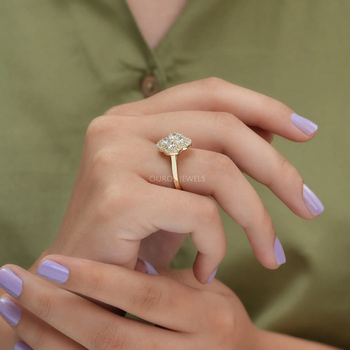 [On Finger Side View Of Round Diamond Floral Style Halo Engagement Ring Made In 14K Yellow Gold]