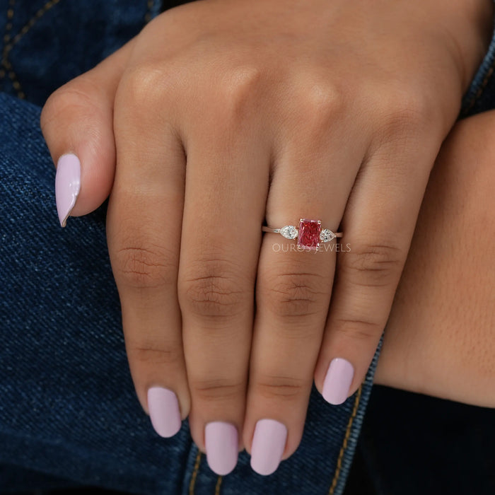 In Finger View Of Pink Radiant Cut Lab Diamond Three Stone Engagement Ring