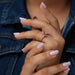 In Finger Side View Of 1 Carat Pink Radiant Cut Three Diamond Engagement Ring
