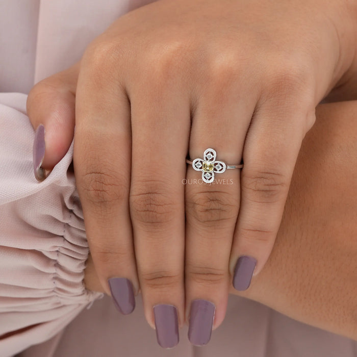 Front finger view of asscher cut diamond ring, center diamond color yellow with VS clarity.