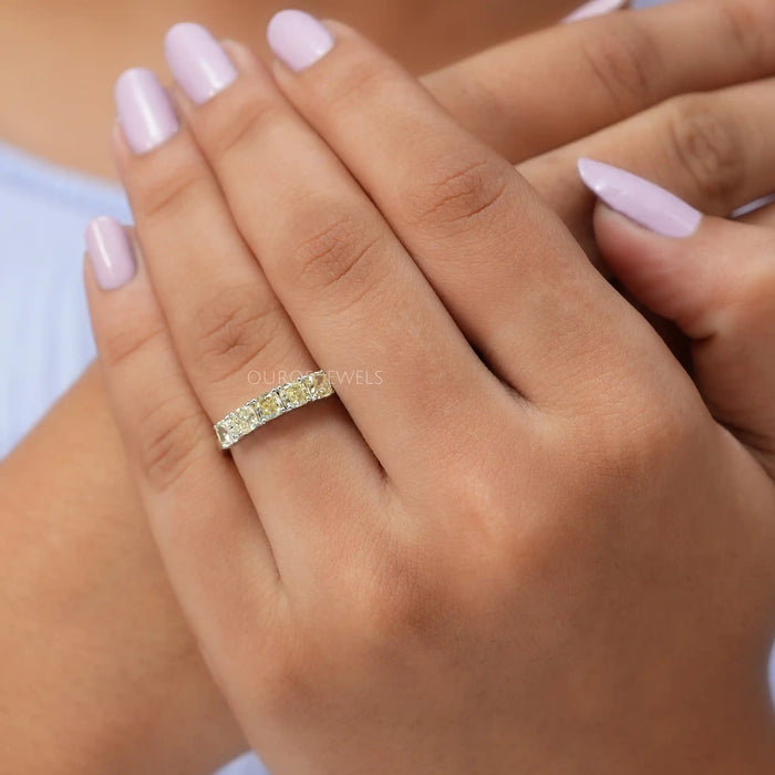 In finger front look of cushion cut lab made diamond wedding ring in solid gold